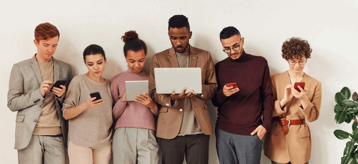 Support | curaJOY A group of people looking at their phones.